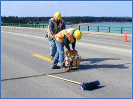 men striping roadway